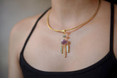 Petroleum Quartz Ruby Aquamarine Clear Quartz dreamcatcher pendant in 18k gold-plated sterling silver shown worn on the chest.