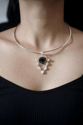 Green Tourmaline Moonstone halo pendant in high-shine 925 sterling silver, shown worn on a model with fine silver chain.