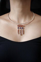 Oracle of Embers pendant shown worn on the chest, with Red Kyanite, Amethyst dangles, mica shimmer, and sterling silver setting.