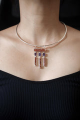 Oracle of Embers pendant shown worn on the chest, with Red Kyanite, Amethyst dangles, mica shimmer, and sterling silver setting.