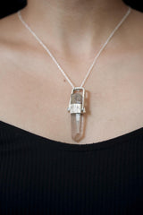 Lemurian Light Spire pendant shown worn on the chest, with long raw Quartz point and polished silver wrap setting.