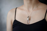 Australian Lemurian Laser Quartz spinning pendant shown worn on the chest, with scratch-textured 925 sterling silver wrap.