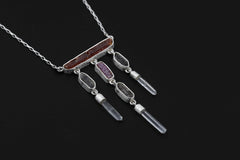 Crimson Ascension Talisman shown on a dark background with Red Kyanite, Ruby, Petroleum Smoky Quartz, Clear Quartz, and sterling silver chain.