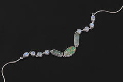 Celestial River necklace shown on a dark background with flowing Turquoise, Aquamarine, and Rainbow Moonstone gemstone layout.