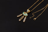 Golden Whisper pendant shown on a dark background with Arizona Turquoise, blue Opal, and three Clear Quartz dangles in gold-plated silver.