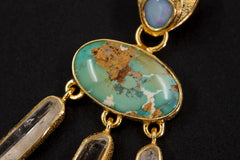 Close-up of Arizona Turquoise and blue Opal in an 18k gold-plated sterling silver dream talisman pendant.