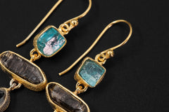 Close-up of Blue Apatite and Petroleum Quartz earrings showing textured 18k gold vermeil bezels and golden inclusions.