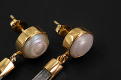 South Sea Pearl and raw Aquamarine earrings displayed on dark background, with 18k gold-plated sterling silver settings.