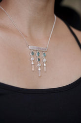 Aurora Alignment necklace shown worn on the chest, with Pink Kunzite, Blue Apatite, Moonstone, Clear Quartz, and sterling silver.