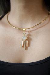Lunar Waters Talisman shown worn on the chest, with Aquamarine, Blue Moonstone, and Clear Quartz dangles in gold-plated silver.