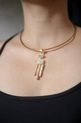 Lunar Waters Talisman shown worn on the chest, with Aquamarine, Blue Moonstone, and raw Stick Pearls in gold-plated silver.