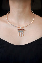 Flame and Tide Harmony pendant shown worn on the chest, with raw Red Kyanite, Aquamarine, and three Clear Quartz dangles.