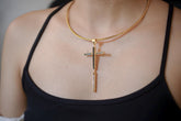 Sacred Shield of Light cross pendant shown worn on the chest, with raw Black Tourmaline, Aquamarine, and Clear Quartz in gold-plated silver.
