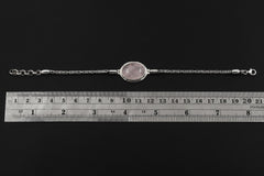 Adjustable Rose Quartz sterling silver bracelet shown beside a ruler with 18 to 21 cm fit reference.