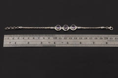 Amethyst sterling silver bracelet shown beside a ruler for adjustable 18 to 21 cm length reference.