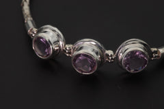 Close view of Amethyst bracelet showing three AAA purple stones in polished sterling silver settings.