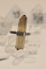 Raw Smoky Citrine ring displayed on clear quartz, with vertical Australian crystal point and oxidized sterling silver band.