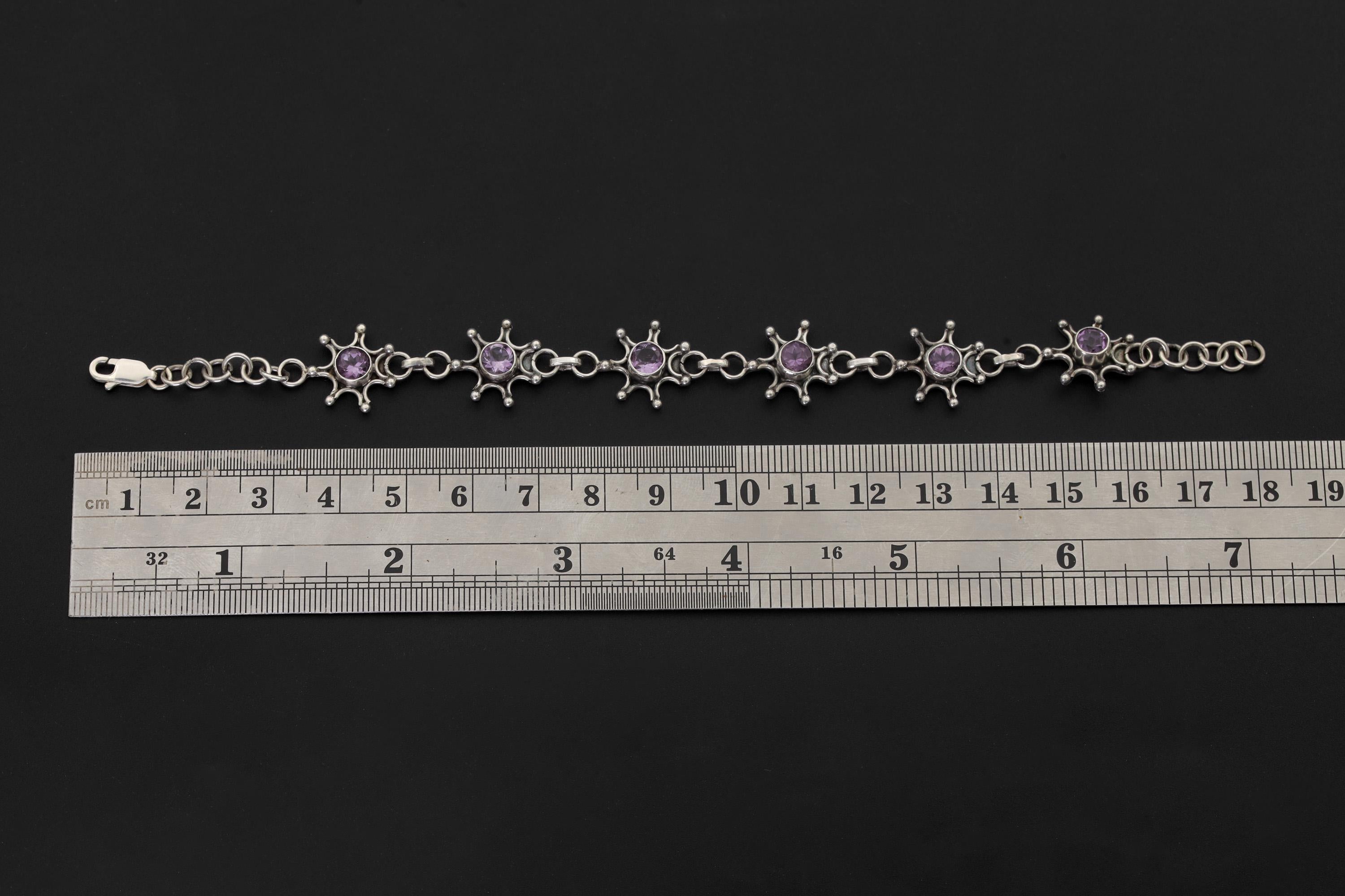 Amethyst starburst sterling silver bracelet shown beside a ruler for 18 to 20 cm adjustable length reference.