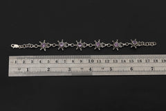 Amethyst starburst sterling silver bracelet shown beside a ruler for 18 to 20 cm adjustable length reference.