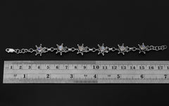 Blue Moonstone sterling silver bracelet shown beside a ruler for adjustable length reference.