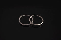 Polished sterling silver Opal hoop earrings shown on a dark background with removable leaf pendant charms.