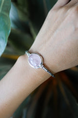 Rose Quartz sterling silver bracelet shown worn on the wrist as a soft Heart Chakra gemstone piece.