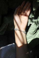 Blue Moonstone sterling silver bracelet shown worn in sunlight with glowing moonstone cabochons.