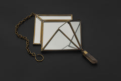 Quartz Reliquary hanging decoration displayed on dark background with aged brass frame, mirrored panels, and crystal drop.