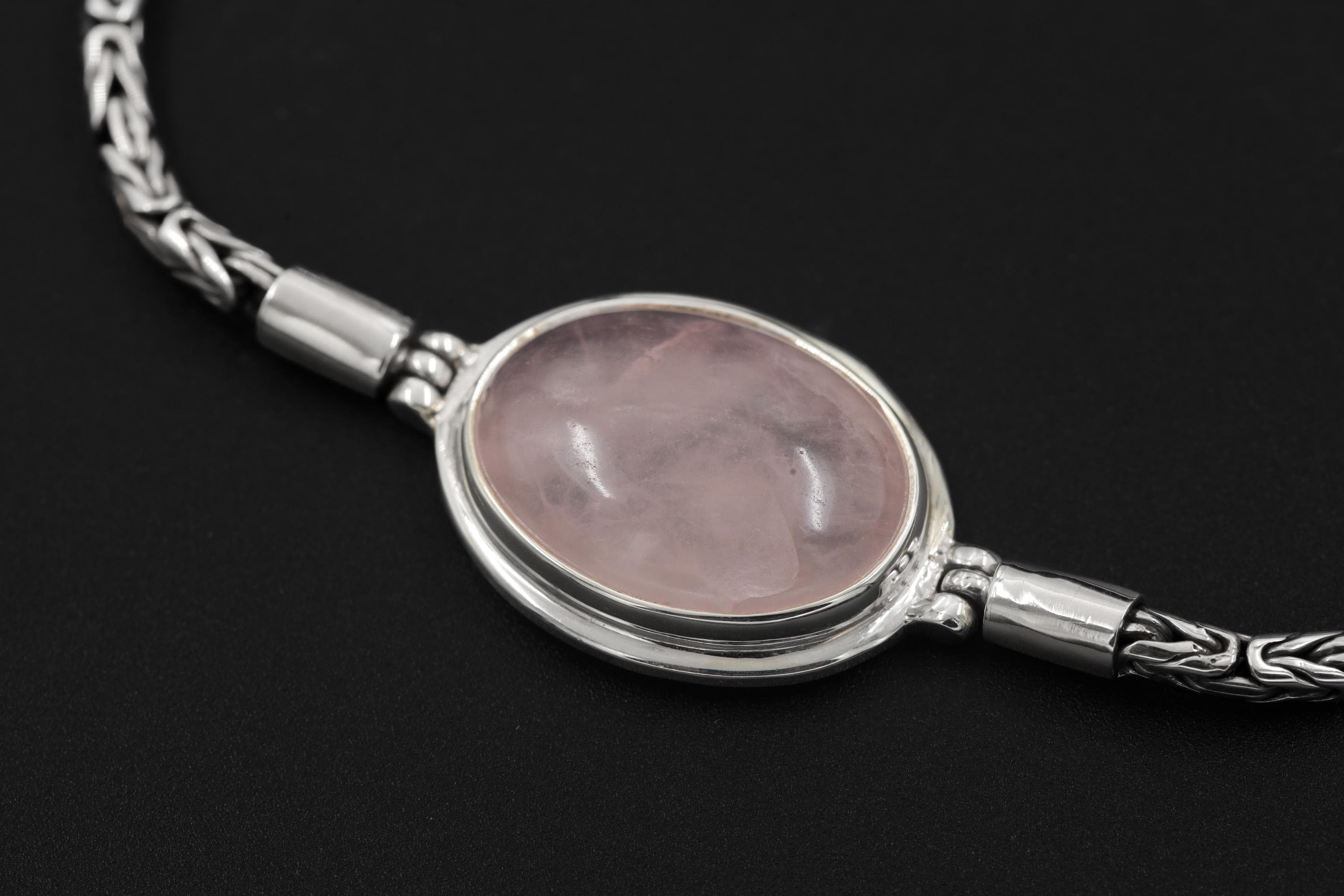 Close view of Rose Quartz bracelet showing translucent pink stone in polished sterling silver bezel setting.