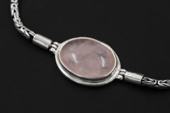 Close view of Rose Quartz bracelet showing translucent pink stone in polished sterling silver bezel setting.