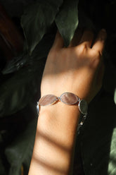 Mother of Pearl sterling silver bracelet shown worn on the wrist with soft oval shell cabochons.shadows.