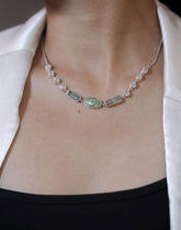 Celestial River necklace shown worn on the chest, with Sleeping Beauty Turquoise, Aquamarine, Rainbow Moonstone, and sterling silver.