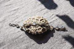 Blue Moonstone sterling silver bracelet shown on textured stone with luminous oval cabochons and toggle clasp.