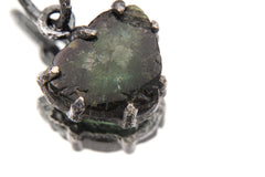 Green Tourmaline Wand Pendant on white background with oxidized sterling silver claw setting and deep green crystal.