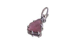 Pink Tourmaline Rubellite pendant on white background showing triangular stone shape, dark rind, and oxidized silver claws.