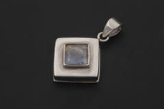 Labradorite sterling silver locket shown worn as a geometric keepsake pendant.