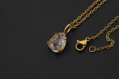 Herkimer Diamond Quartz pendant shown with adjustable necklace chain on black background.