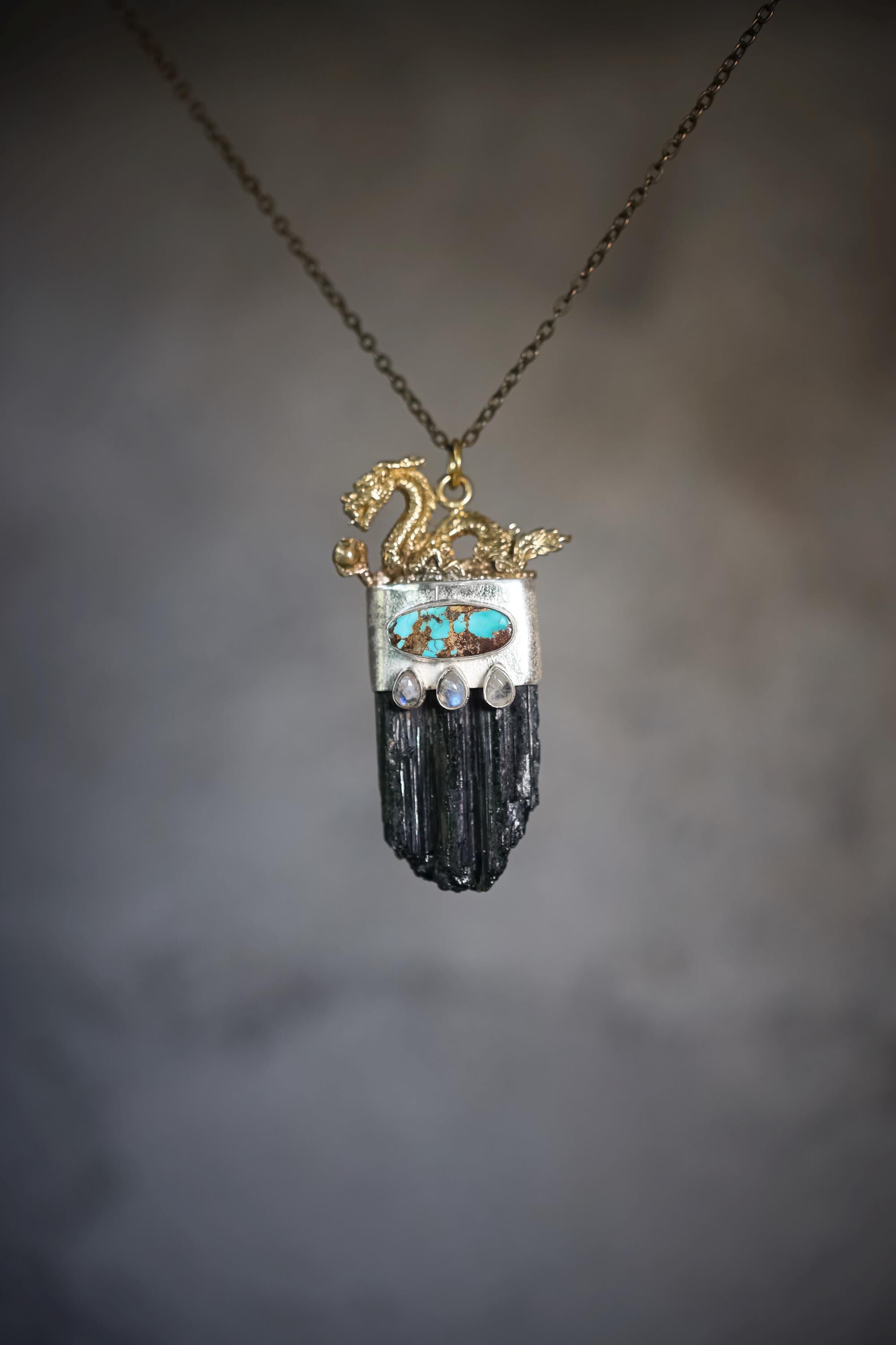 Dragon Black Tourmaline Turquoise Moonstone pendant shown on misty background with sterling silver and protective talisman design.
