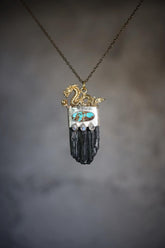 Dragon Black Tourmaline Turquoise Moonstone pendant shown on misty background with sterling silver and protective talisman design.