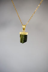Green Tourmaline Stack Pendant shown worn on a model, with compact vertical shape and warm gold-plated setting.