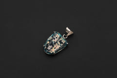 Ancient opalized glass pendant displayed on black background with claw-set sterling silver frame.