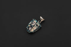 Ancient opalized glass pendant displayed on black background with claw-set sterling silver frame.