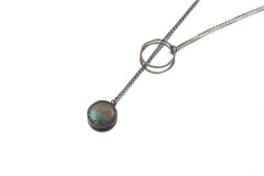 Turquoise lariat necklace displayed on white background with textured silver loop and chain.