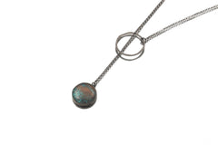 Turquoise lariat necklace displayed on white background with textured silver loop and chain.
