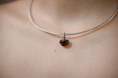 Rubellite Pink Tourmaline pendant shown worn on a silver necklace, with compact oxidized sterling silver claw setting.