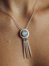Blue Moonstone Lunar Ray pendant shown worn on a model, with high-shine sterling silver rays and luminous central stone.