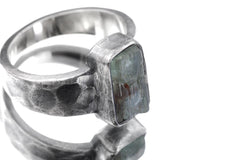 Close-up of Australian Aquamarine men’s ring showing square blue mineral specimen and thick hammered silver bezel.