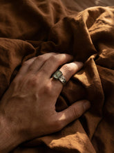 Australian Aquamarine specimen ring in oxidized 925 sterling silver shown worn on the hand with rugged hammered band.