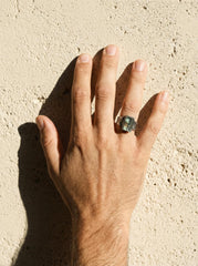 Australian Aquamarine ring shown worn outdoors, with square blue gemstone and rugged oxidized sterling silver band.