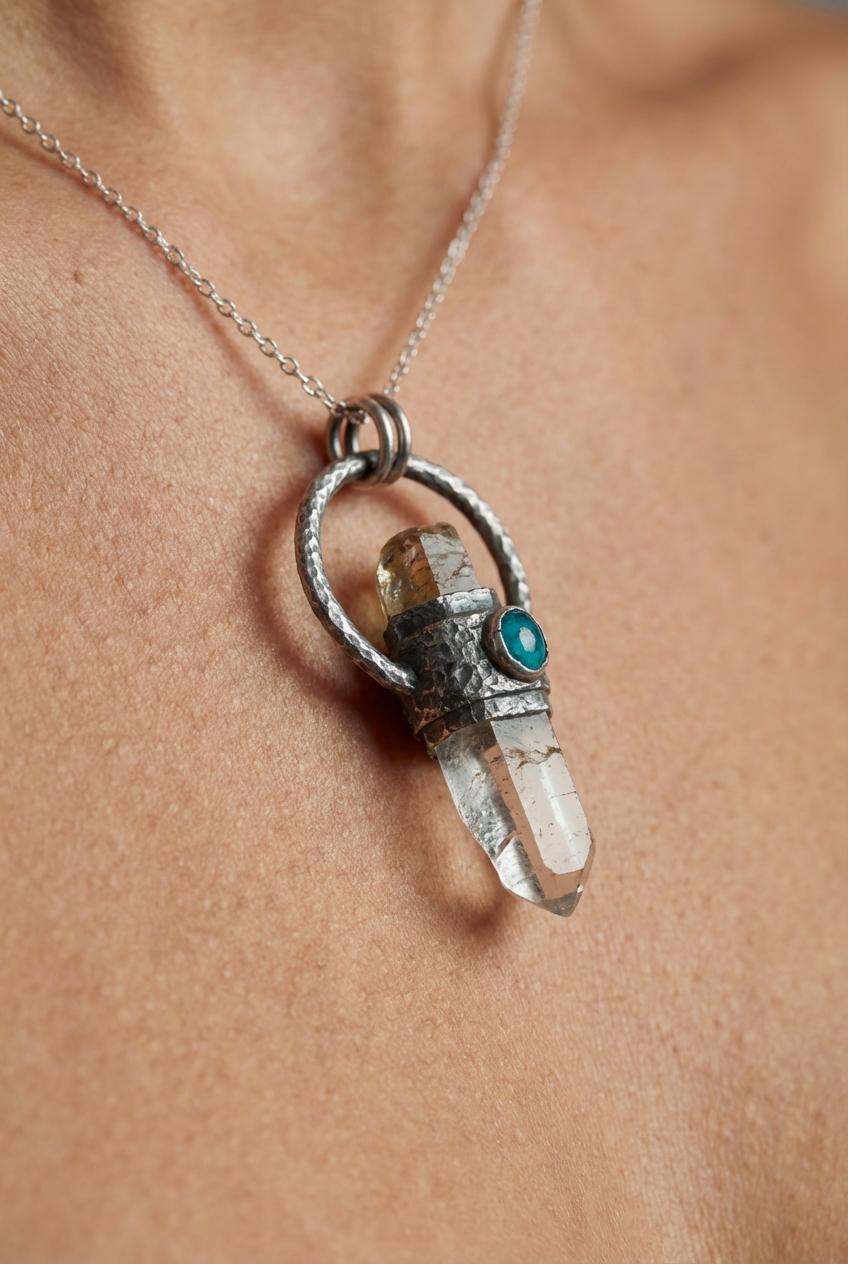 Brown Tourmaline Emerald Lemurian Quartz pendant shown worn on a model, with oxidized sterling silver and raw crystal point.
